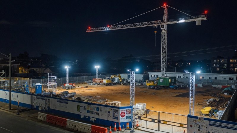 NSW construction compound at night — a static gate post after hours